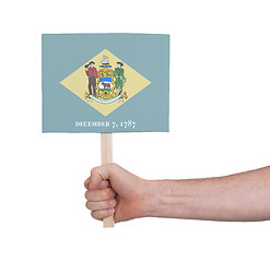 Image showing Hand holding small card - Flag of Delaware