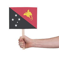 Image showing Hand holding small card - Flag of Papua New Guinea