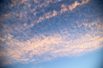 Image showing sunrise in the colored sky white soft clouds moon