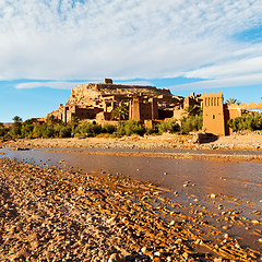 Image showing sunset in africa old construction near the river blue