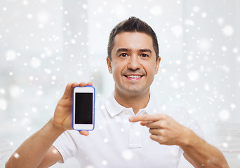 Image showing happy man with smartphone at home