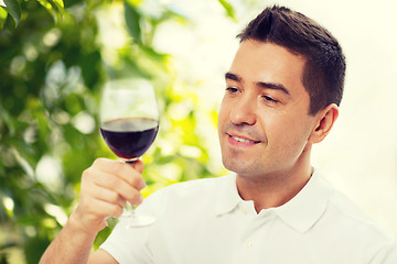 Image showing happy man drinking red wine from glass
