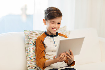 Image showing smiling boy with tablet computer at home