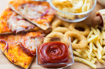 Image showing close up of fast food snacks on wooden table