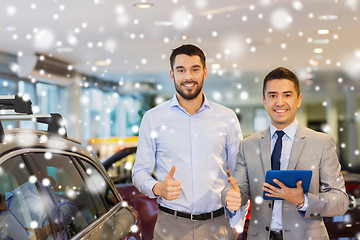 Image showing happy man showing thumbs up in auto show or salon