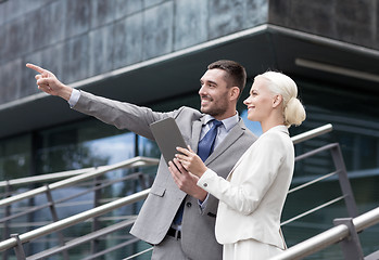 Image showing smiling businessmen with tablet pc outdoors