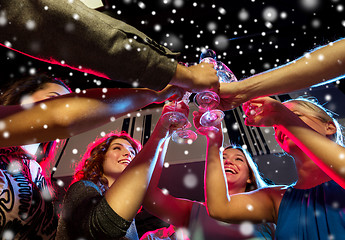 Image showing smiling friends with glasses of champagne in club