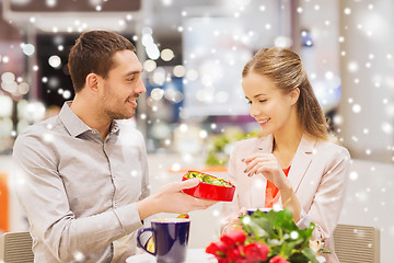 Image showing happy couple with chocolate box and roses in mall