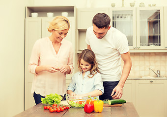 Image showing happy family making dinner in kitchen