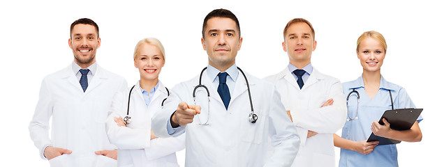 Image showing group of doctors with clipboard pointing at you