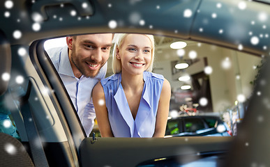 Image showing happy couple buying car in auto show or salon