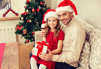 Image showing smiling father and daughter holding gift box