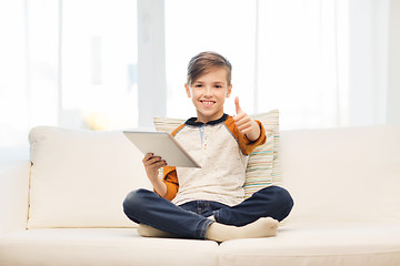 Image showing smiling boy with tablet showing thumbs up at home