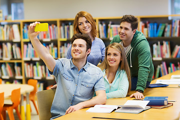 Image showing students with smartphone taking selfie in library