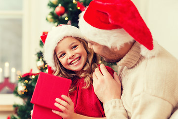 Image showing smiling father and daughter opening gift box