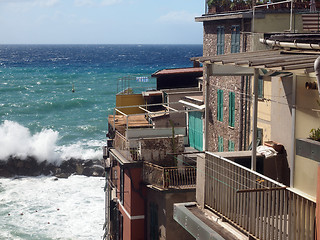 Image showing Riomaggiore Cinque Terre Italy waves breaking against historic h