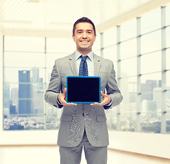 Image showing happy businessman in suit showing tablet pc screen