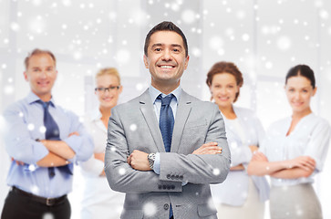 Image showing happy businessman over team at office