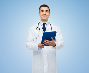 Image showing smiling male doctor in white coat with tablet pc