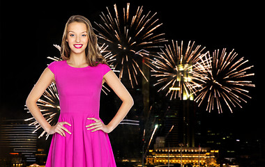 Image showing happy young woman over firework at night city