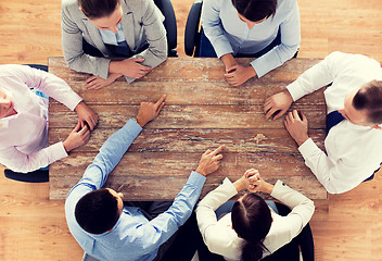 Image showing close up of business team sitting at table