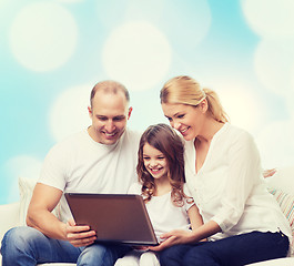 Image showing smiling family with laptop