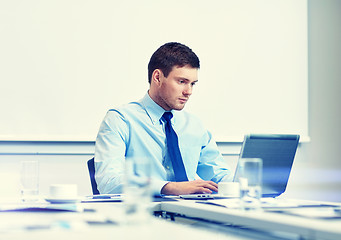 Image showing businessman with laptop working in office