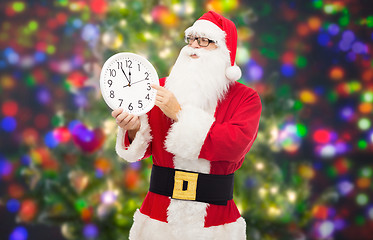 Image showing man in costume of santa claus with clock