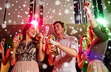 Image showing smiling friends with wine glasses and beer in club