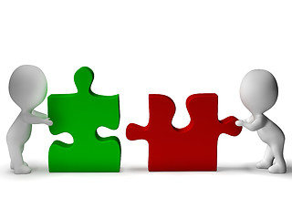 Image showing Jigsaw Pieces Being Joined Shows Teamwork And Collaboration