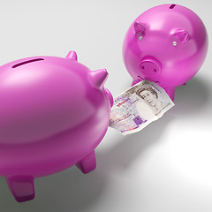 Image showing Piggybanks Fighting Over Money Showing Savings