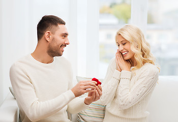 Image showing man giving woman engagement ring for christmas