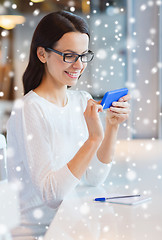 Image showing smiling woman with smartphone at cafe