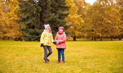 Image showing two happy little girls in autumn park