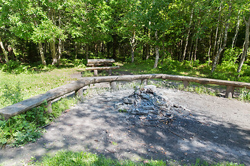 Image showing camp fire place with bench seats in forest