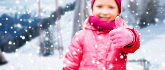 Image showing happy girl showing thumbs up over winter