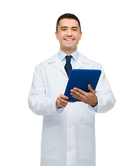 Image showing smiling male doctor in white coat with tablet pc