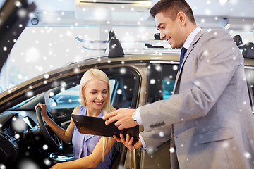 Image showing happy woman with car dealer in auto show or salon