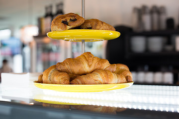 Image showing close up of croissants and buns on cake stand