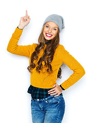 Image showing happy young woman or teen girl pointing finger up