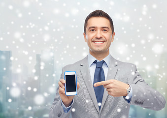 Image showing happy businessman showing smartphone screen