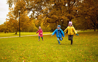 Image showing group of happy little kids running outdoors