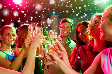 Image showing smiling friends with glasses of champagne in club