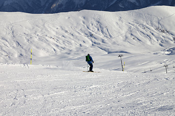 Image showing Skier on slope in sun evening