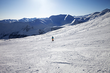 Image showing Skier on slope in sun day