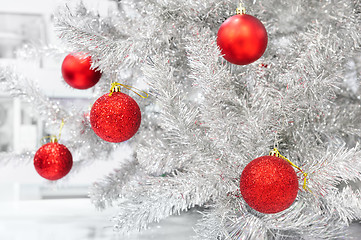 Image showing Red baubles on silver artificial christmas tree