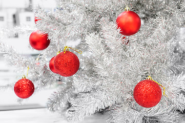 Image showing Red baubles on silver artificial christmas tree