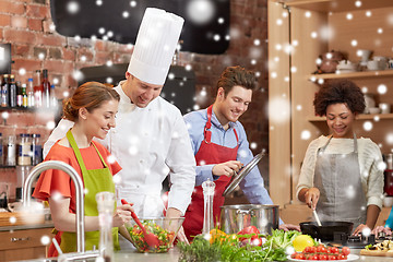 Image showing happy friends and chef cook cooking in kitchen