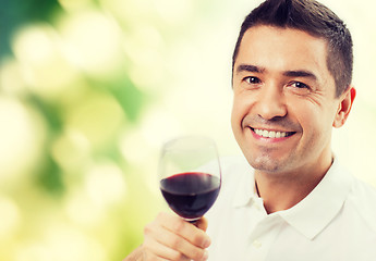 Image showing happy man drinking red wine from glass