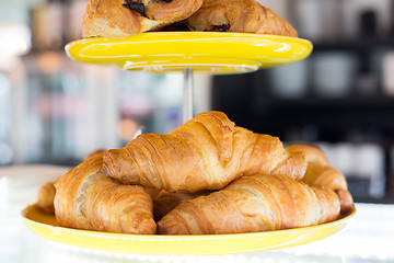 Image showing close up of croissants and buns on cake stand